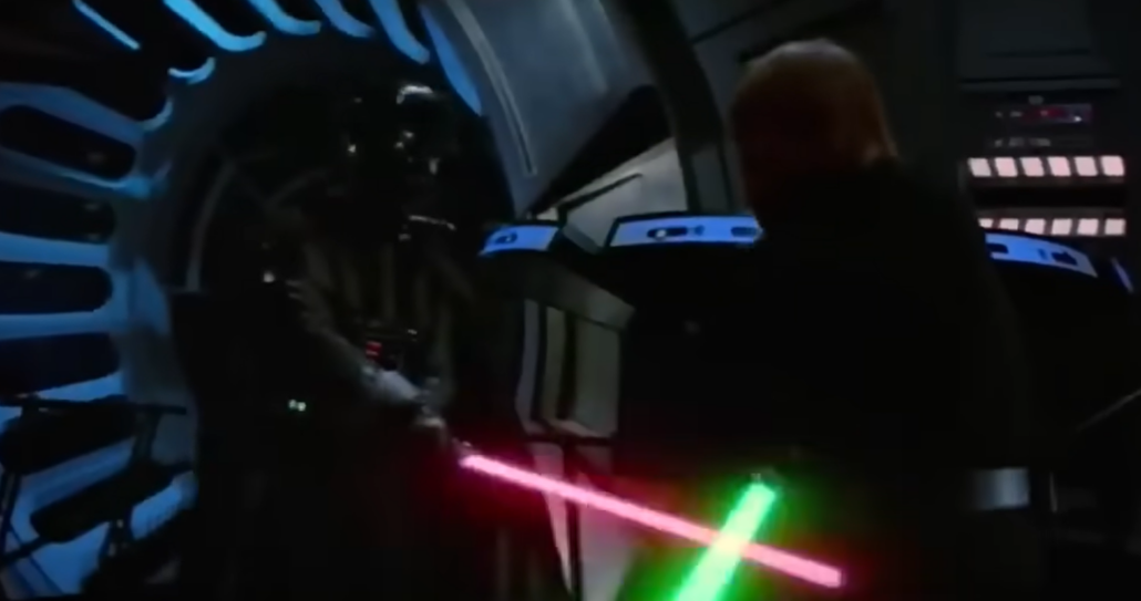 darth vader fighting with oponent with red and green swords in star wars film