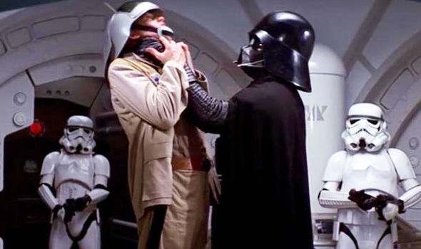 Darth Vader holds a Jedi by the neck