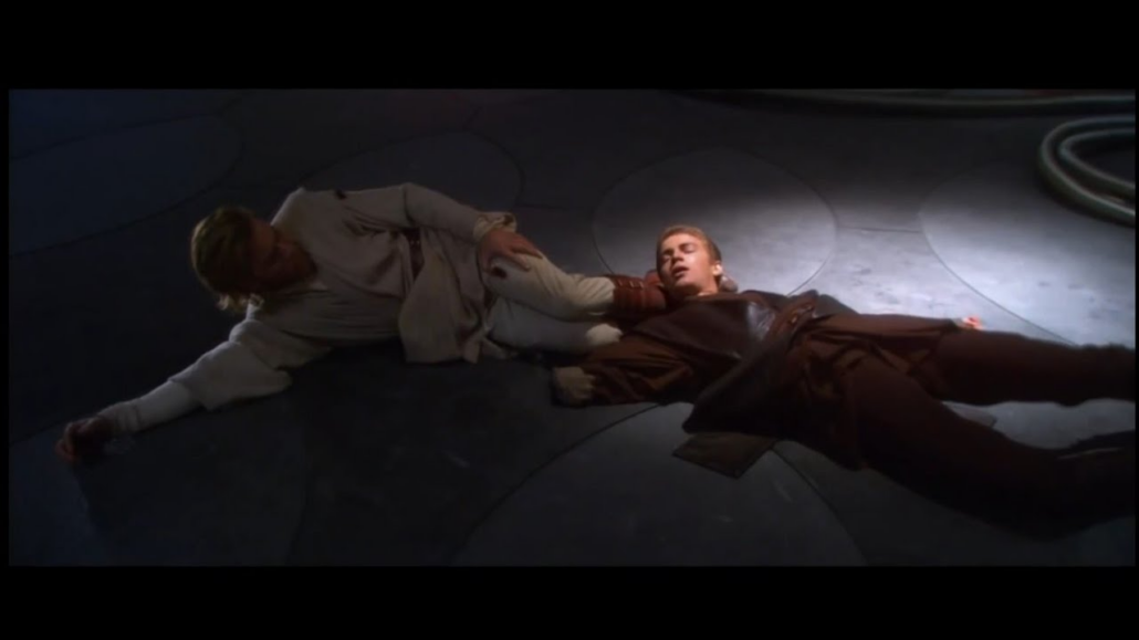 Anakin lies on the floor without a hand, a Jedi is nearby