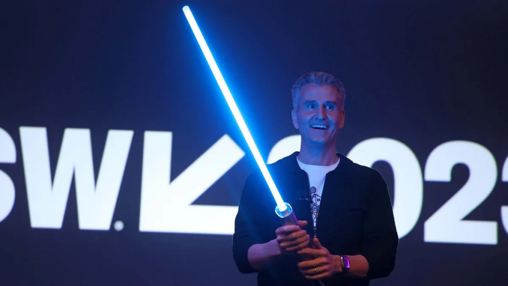 A man holding a lightsaber